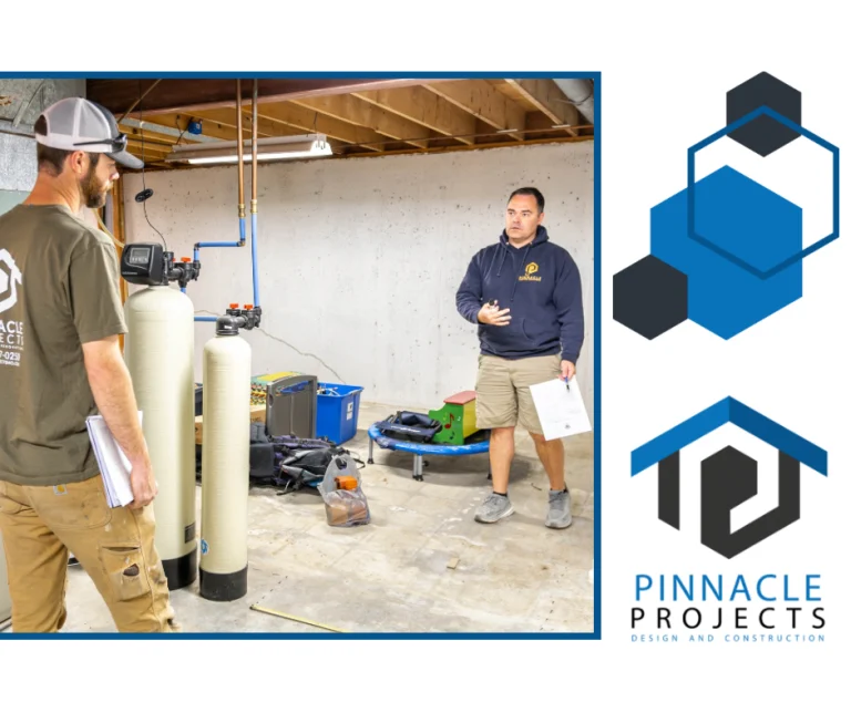 Two men standing beside water-treatment tanks in a basement, with the Pinnacle Projects Design and Construction logo